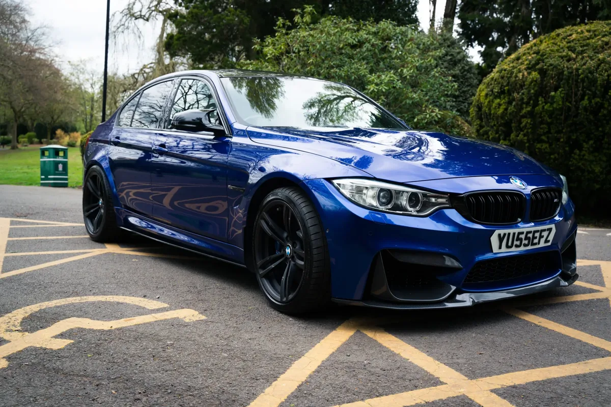 Blue BMW M3 parked in a London park