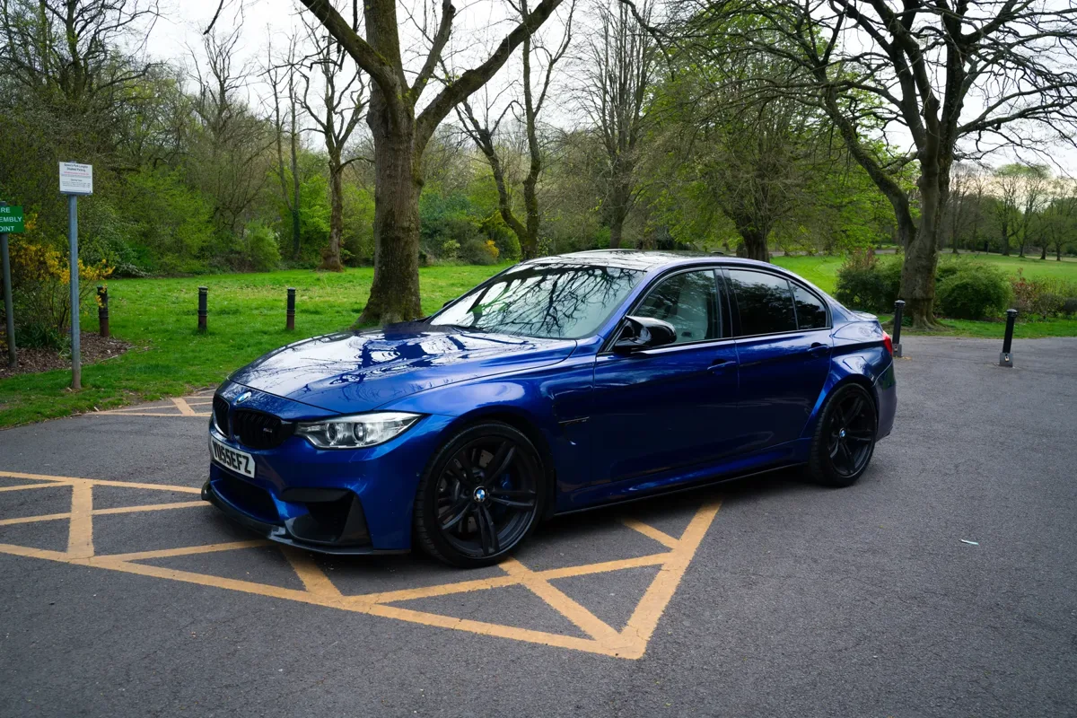 BMW M3 front view on park driveway